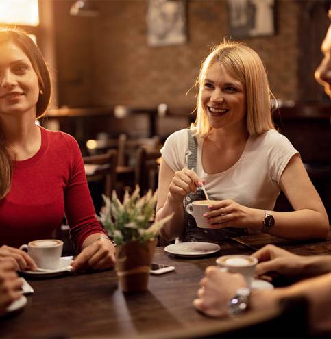 group-happy-friends-gathering-cafe-enjoying-their-coffee-time-while-talking-each-other